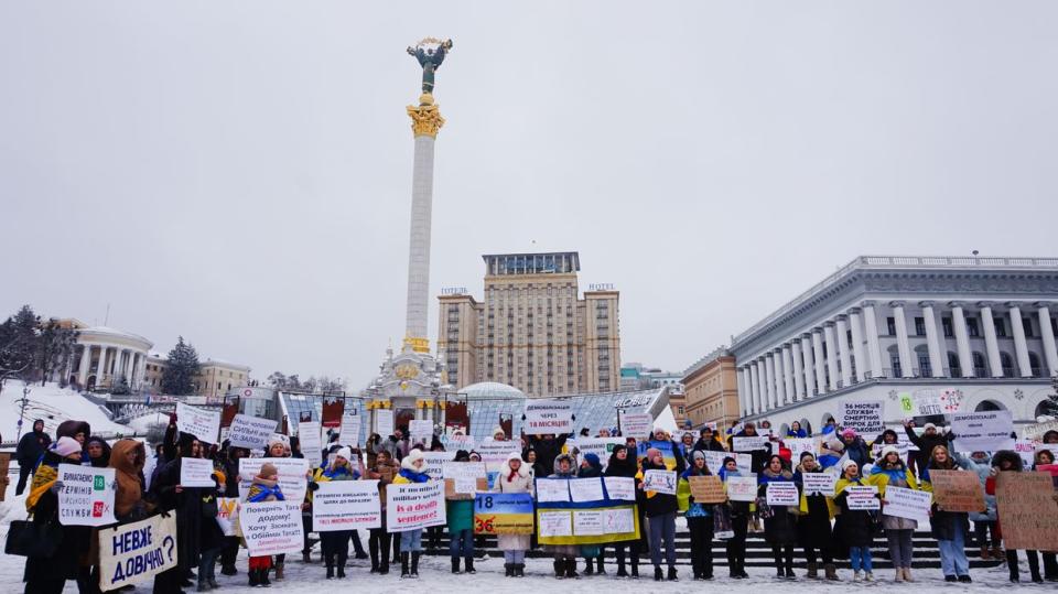 On Dec. 8, 2023, more than a hundred women gathered at Maidan Square in downtown Kyiv, holding signs urging the government to demobilize their husbands who have been on the front lines since the onset of the Russian full-scale invasion. (Alexander Query/The Kyiv Independent)