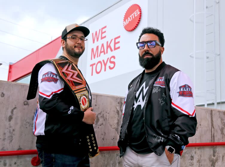 Bruce Reyes, 33 of Downey, left, and George Martinez, 36 of Lennox, right, design WWE figures packaging for Mattel, at the Mattel Design Center in El Segundo on Friday, April 14, 2023.