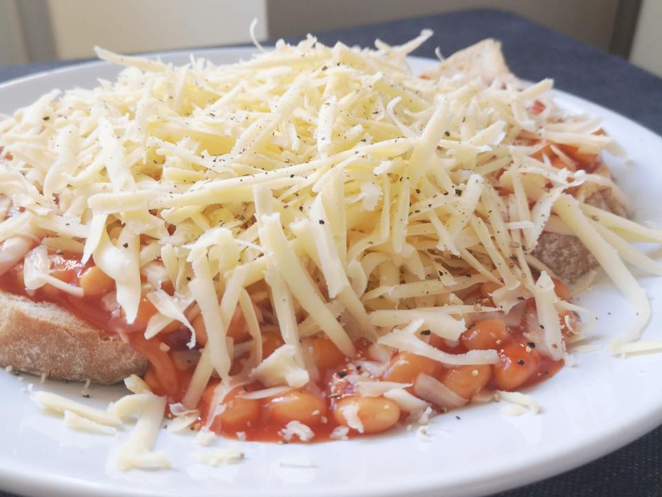 beans on toast with shredded cheese on top