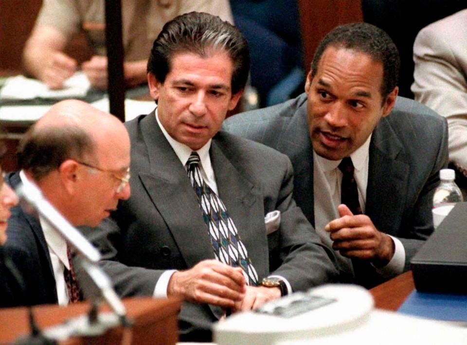 A May 1995 file photo shows murder defendant O.J. Simpson, right, consulting with friend Robert Kardashian, center, and Alvin Michelson, left, the attorney representing Kardashian, during a hearing in Los Angeles.