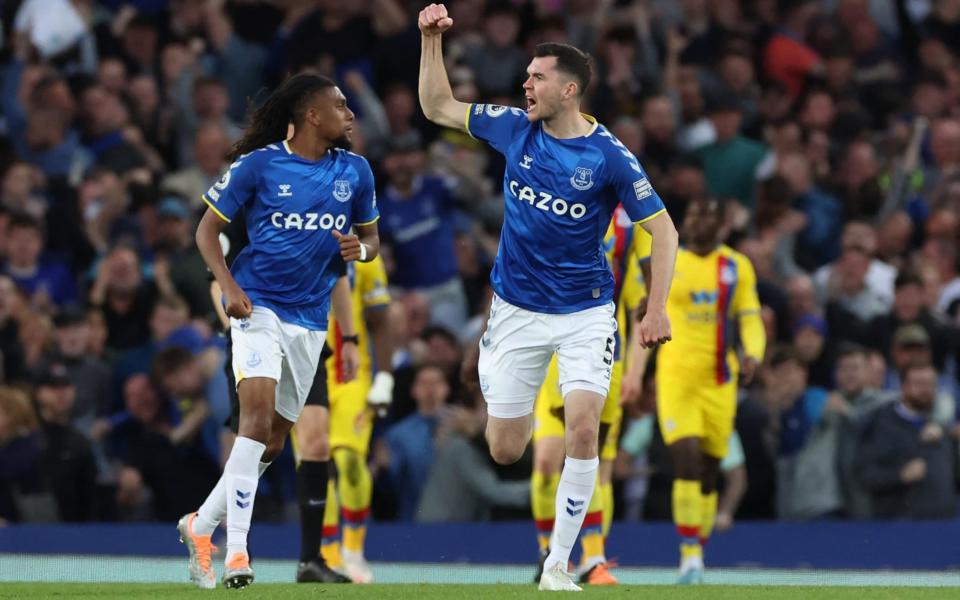 Michael Keane pumps his fist as he charges back towards the centre circle - REUTERS