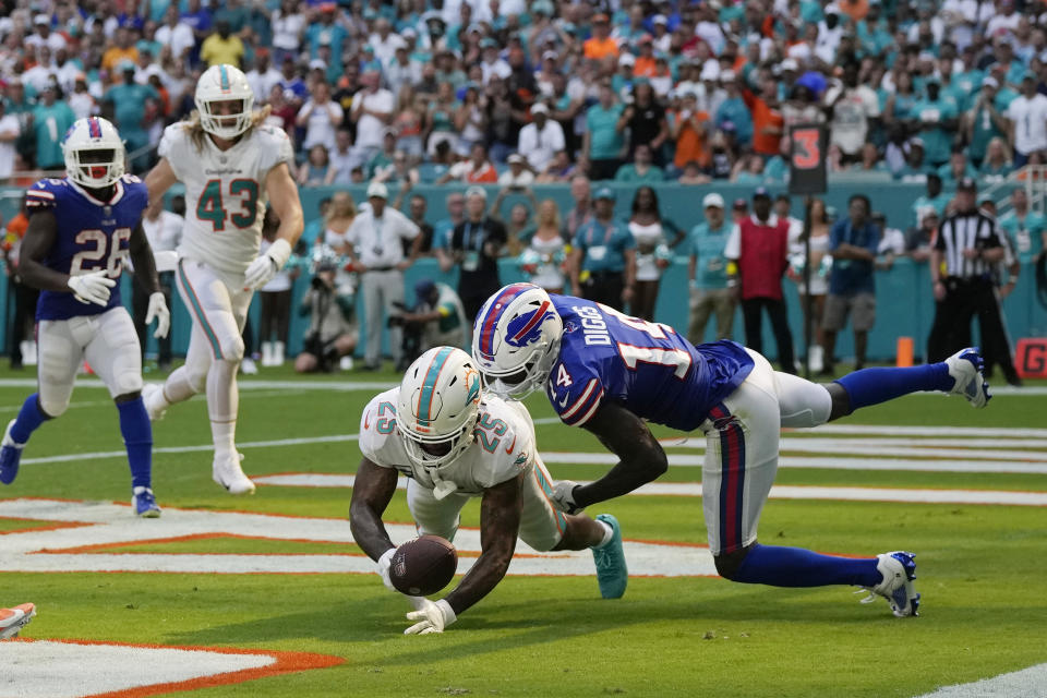 Buffalo Bills wide receiver Stefon Diggs (14) drops the ball under pressure from Miami Dolphins cornerback Xavien Howard (25) during the second half of an NFL football game, Sunday, Sept. 25, 2022, in Miami Gardens, Fla. The Dolphins defeated the Bills 21-19. (AP Photo/Rebecca Blackwell)