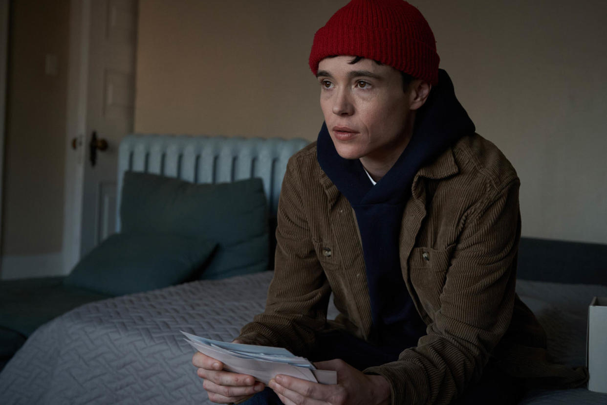 Elliot Page sitting on bed holding papers in recent film 'Close to You.' (Courtesy of Greenwich Entertainment)