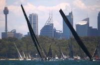 The yachts Perpetual Loyal (L) and Scallywag sail on Sydney Harbour during the start of the annual Sydney to Hobart Yacht race, Australia's premiere bluewater classic, in Australia, December 26, 2016. REUTERS/David Gray