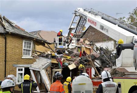 Emergency services work at the scene of a fallen tree at Bath Road in Hounslow, west London October 28, 2013. REUTERS/Toby Melville