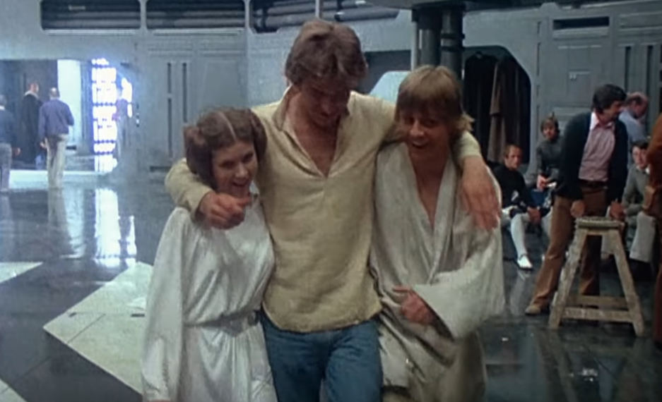 Carrie Fisher, Harrison Ford and Mark Hamill on the set of Star Wars (Credit: Lucasfilm)