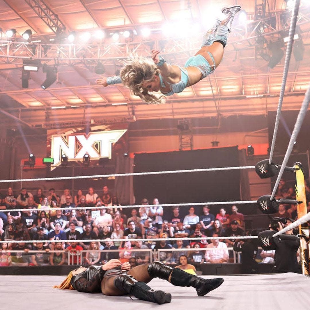 WWE NXT's Tiffany Stratton delivers a diving senton splash to multiple-time WWE women's champion Becky Lynch