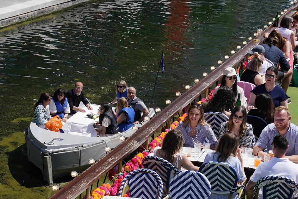 <p>People enjoy the hot weather at the canal in Paddington Basin, north London, as Bank Holiday Monday could be the hottest day of the year so far - with temperatures predicted to hit 25C in parts of the UK. Picture date: Monday May 31, 2021.</p>
