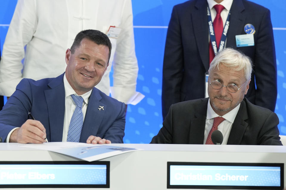 CEO of IndiGo Pieter Elbers, left, and Airbus Chief Commercial Officer and Head of International Christian Scherer pose for a picture with signed documents during a news conference during the Paris Air Show in Le Bourget, north of Paris, France, Monday, June 19, 2023. (AP Photo/Lewis Joly)