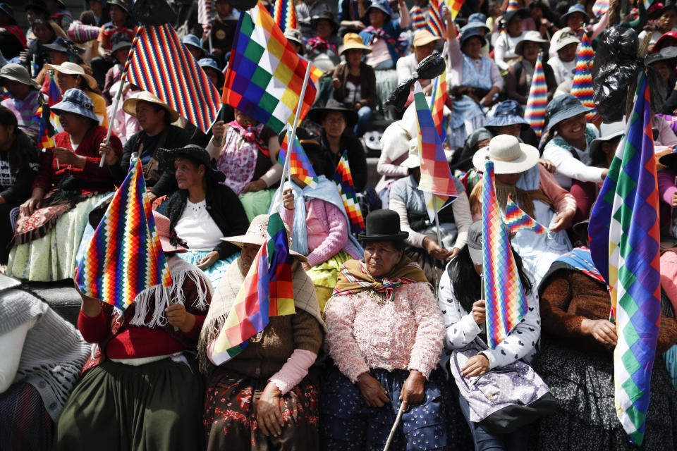 Women, holding the multicolor “Wiphala” flag that represents indigenous peoples, take part in a meeting of backers of former President Evo Morales to discuss how to successfully continue their protests, in La Paz, Bolivia, Saturday, Nov. 16, 2019. Morales resigned the presidency and fled into exile in Mexico on Nov. 10, claiming a coup d’etat following massive protests accusing him of engineering a fraudulent reelection. (AP Photo/Natacha Pisarenko)