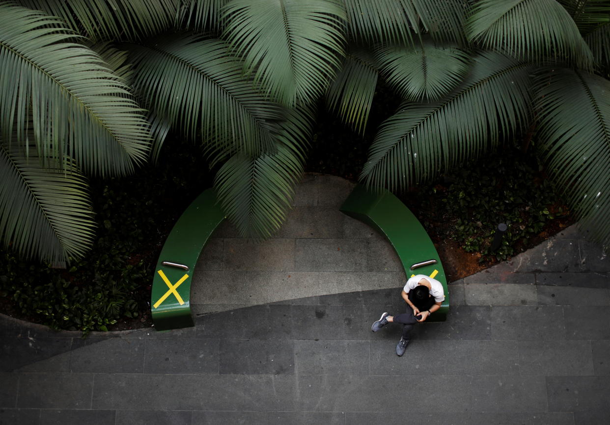 A man sits at a rest area at a mall during the coronavirus disease (COVID-19) outbreak, in Singapore, September 23, 2021. REUTERS/Edgar Su