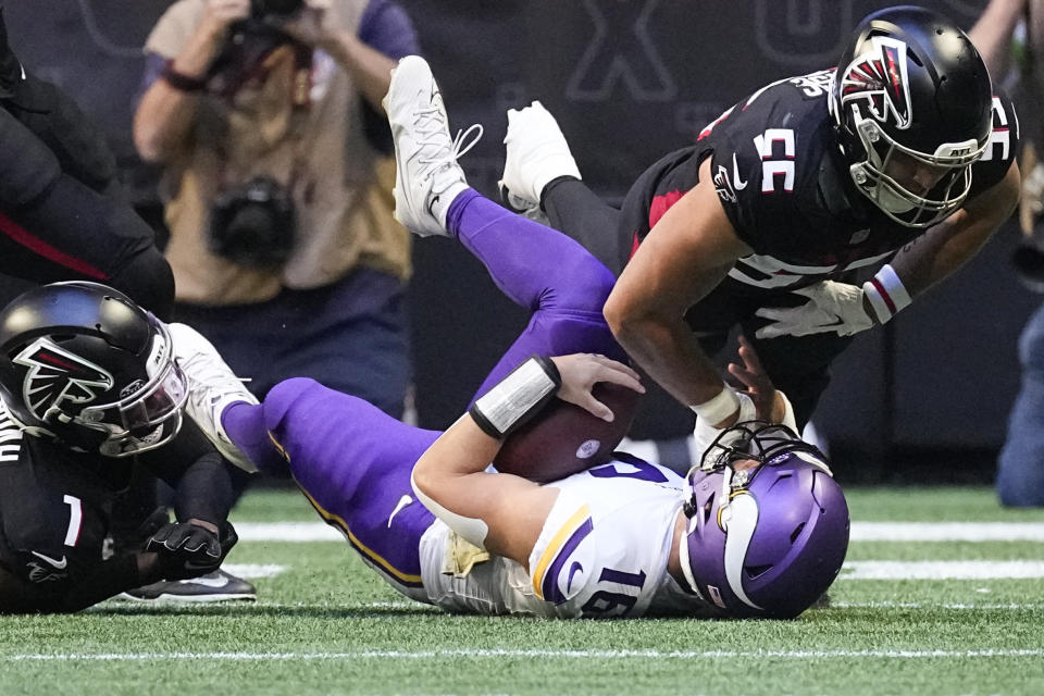 Minnesota Vikings quarterback Jaren Hall, center, is tackled by Atlanta Falcons linebacker Kaden Elliss (55) and cornerback Jeff Okudah (1) during the first half of an NFL football game, Sunday, Nov. 5, 2023, in Atlanta. Hall was injured on the play. (AP Photo/John Bazemore)