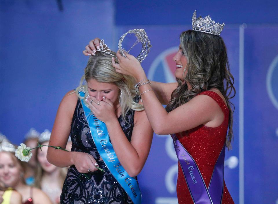 Outgoing Iowa State Fair Queen Hannah Koellner crowns Plymouth County's McKenna Henrich after Henrich was named the 2021 Iowa State Fair Queen during the coronation ceremony at the Anne and Bill Riley Stage during the Iowa State Fair on Saturday, Aug. 14, 2021, in Des Moines, Iowa.