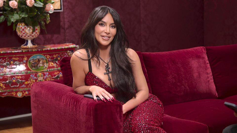 Kim Kardashian in burgundy sitting down in The Kardashians season 4