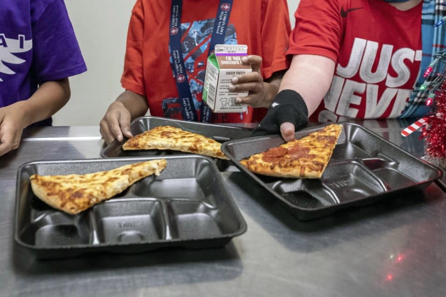 Second-grade students select their meals during lunch break in the cafeteria, Dec. 12, 2022, at an elementary school in Scottsdale, Ariz. (AP Photo/Alberto Mariani, File)