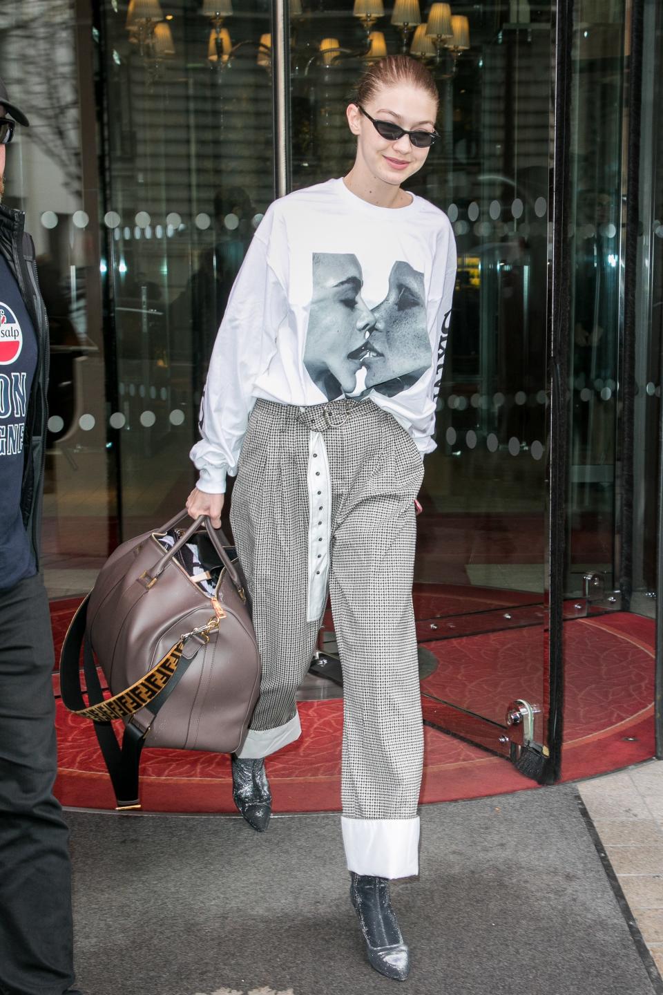 <p>WHO: Gigi Hadid</p> <p>WHAT: Chaos 69 top, Yigal Azrouël trousers, Vogue Eyewear sunglasses, Fendi bag, Stuart Weitzman shoes</p> <p>WHERE: On the street, Paris</p> <p>WHEN: March 29, 2018</p>