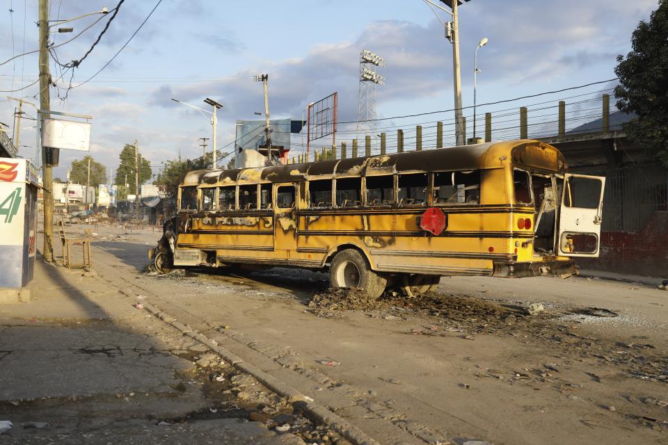 A bus set on fire by gang members at the Portail neighborhood of Port-au-Prince, Haiti, Thursday, Feb. 29, 2024. Gunmen shot at the international airport and other targets in a wave of violence that forced businesses, government agencies and schools to close early. (AP Photo/Odelyn Joseph)