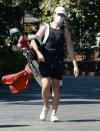 <p>Miles Teller carries his clubs as he heads to the golf course on Tuesday in L.A.</p>