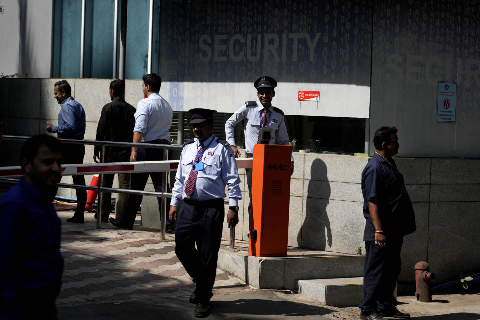 Private security guards stand outside a building housing BBC office, in Mumbai, India, Tuesday, Feb. 14, 2023. Officials from India's Income Tax department began conducting searches Tuesday at the BBC's offices in New Delhi and Mumbai, three of the broadcaster's staff members told the Associated Press. (AP Photo/Rafiq Maqbool)