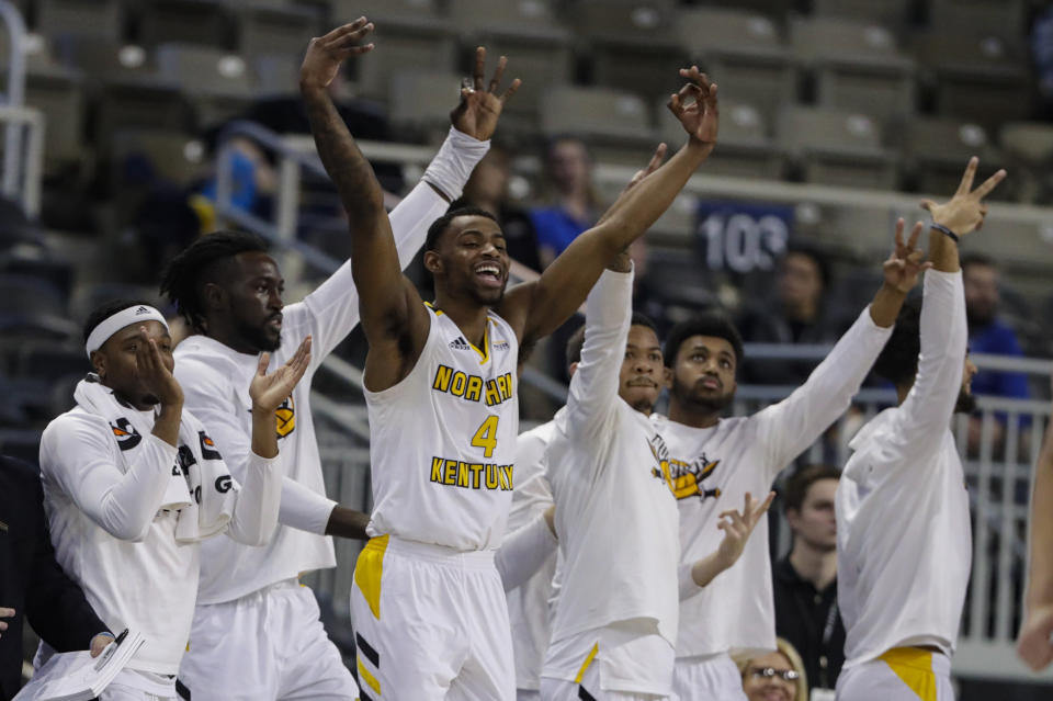 The Northern Kentucky bench, including forward Adrian Nelson (4), celebrate during the second half of an NCAA college basketball game against Illinois-Chicago for the Horizon League men's tournament championship in Indianapolis, Tuesday, March 10, 2020. Northern Kentucky won 71-62. (AP Photo/Michael Conroy)