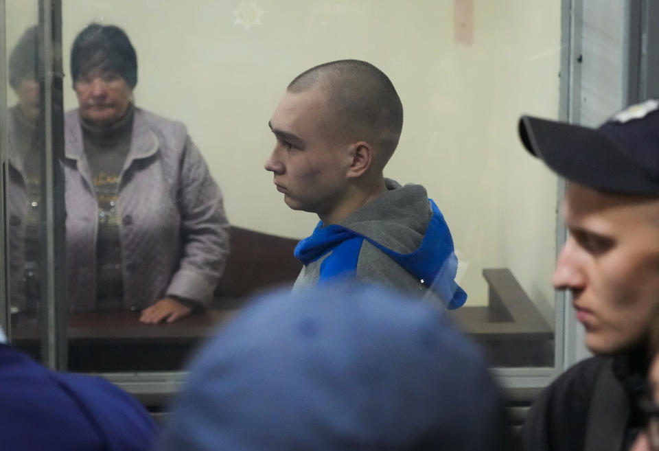 Russian army Sergeant Vadim Shishimarin, 21, is seen behind a glass during a court hearing in Kyiv, Ukraine, Wednesday, May 18, 2022. The Russian soldier has gone on trial in Ukraine for the killing of an unarmed civilian. The case that opened in Kyiv marked the first time a member of the Russian military has been prosecuted for a war crime since Russia invaded Ukraine 11 weeks ago. (AP Photo/Efrem Lukatsky)