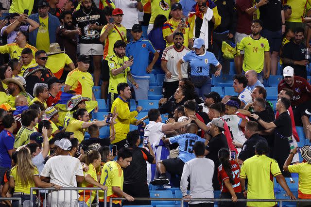 <p>Tim Nwachukwu/Getty</p> Fans of Colombia fight with fans and players of Uruguay after the CONMEBOL Copa America 2024 semifinal match