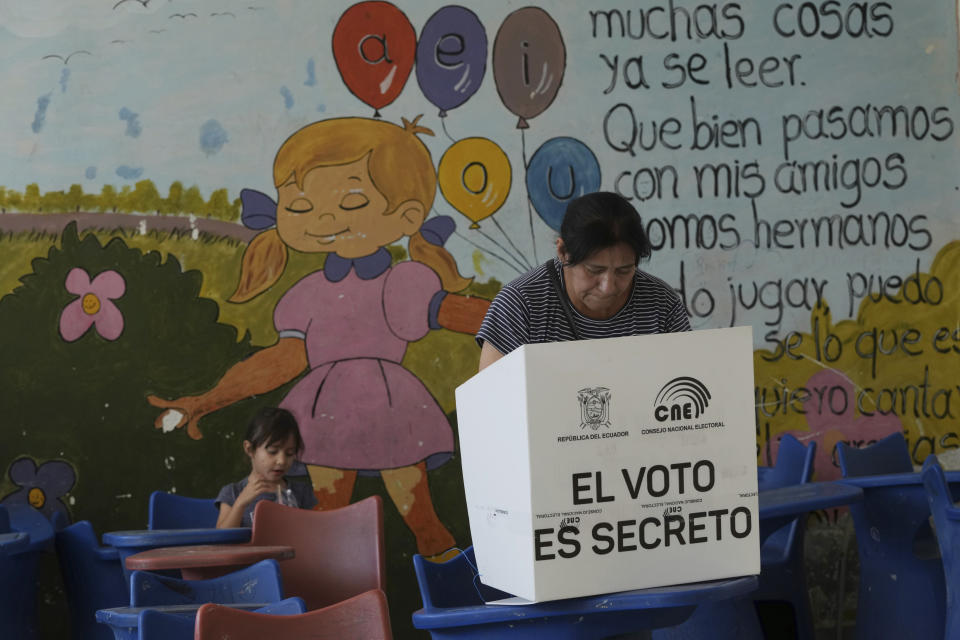 A woman votes in a runoff presidential election in Quito, Ecuador, Sunday, Oct. 15, 2023. (AP Photo/Dolores Ochoa)