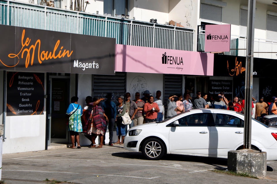 People line-up to buy bread in Magenta district, Noumea, in France's Pacific territory of New Caledonia, May 23, 2024, as French President Emmanuel Macron visits. / Credit: LUDOVIC MARIN/Pool/REUTERS