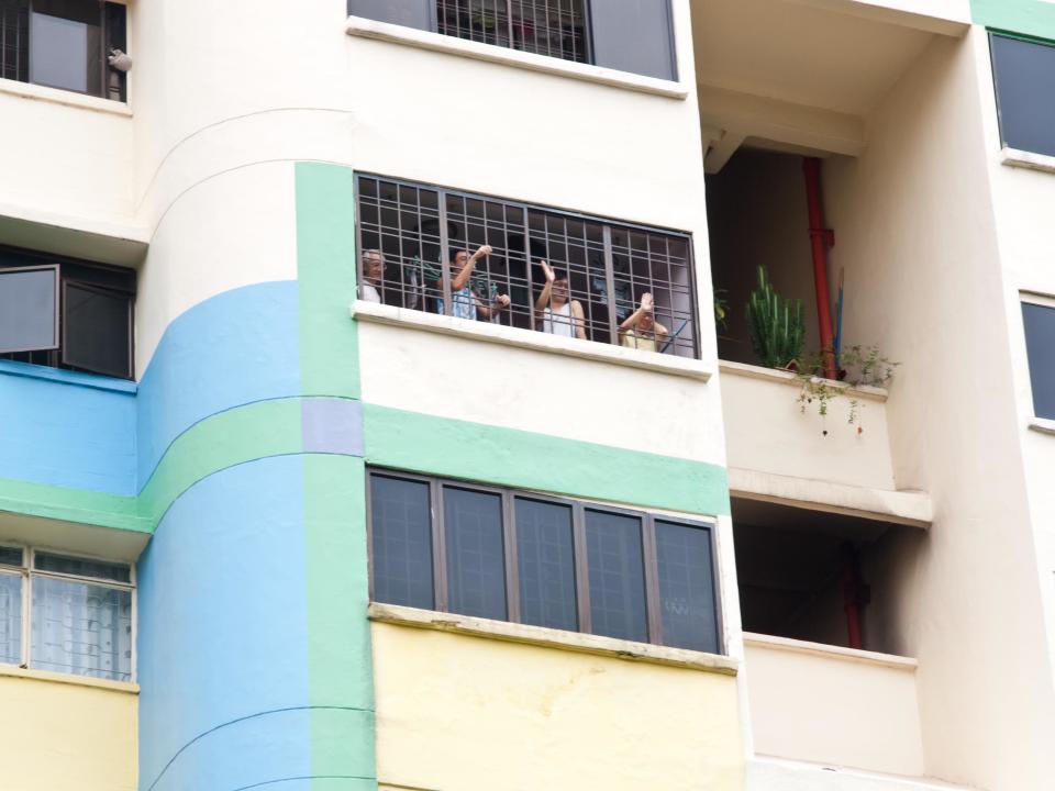 Delighted residents enthusiastically waving to Desmond Choo from their windows. (Yahoo! photo/Alvin Ho)
