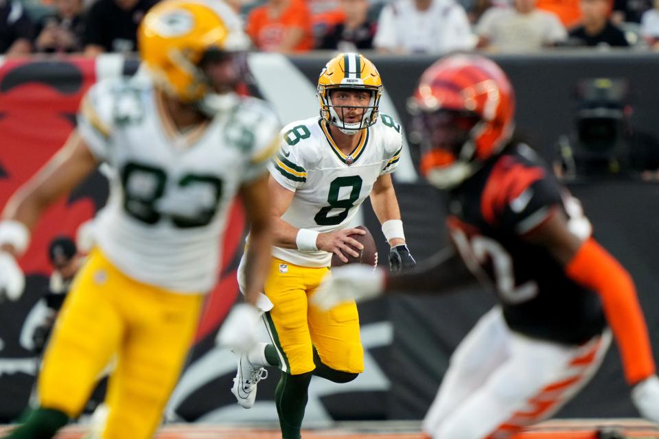 Green Bay Packers quarterback Sean Clifford (8) eyes a pass to Green Bay Packers wide receiver <a class="link " href="https://sports.yahoo.com/nfl/players/34214" data-i13n="sec:content-canvas;subsec:anchor_text;elm:context_link" data-ylk="slk:Samori Toure;sec:content-canvas;subsec:anchor_text;elm:context_link;itc:0">Samori Toure</a> (83), left, in the second quarter during a Week 1 NFL preseason game between the Green Bay Packers and the Cincinnati Bengals,Friday, Aug. 11, 2023, at Paycor Stadium in Cincinnati.