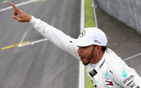 Pole position qualifier Lewis Hamilton of Great Britain and Mercedes GP celebrates in parc ferme during qualifying for the Formula One Grand Prix of Brazil at Autodromo Jose Carlos Pace on November 10, 2018 in Sao Paulo, Brazil - Credit: getty images