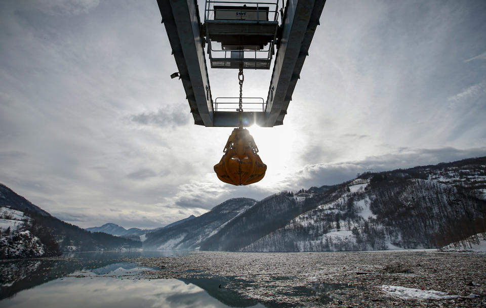 Garbage is stuck at the foot of the hydro power plant at the Potpecko accumulation lake near Priboj, in southwest Serbia, Friday, Jan. 22, 2021. Serbia and other Balkan nations are virtually drowning in communal waste after decades of neglect and lack of efficient waste-management policies in the countries aspiring to join the European Union. (AP Photo/Darko Vojinovic)