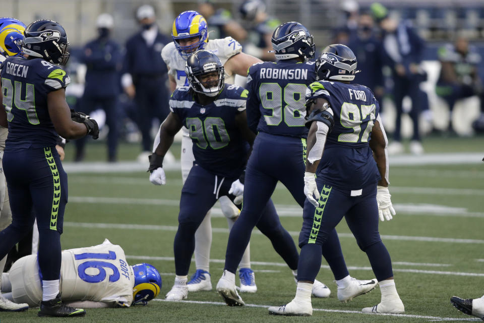 Seattle Seahawks defensive end Alton Robinson (98) reacts with teammates after he sacked Los Angeles Rams quarterback Jared Goff (16) during the second half of an NFL football game, Sunday, Dec. 27, 2020, in Seattle. (AP Photo/Scott Eklund)