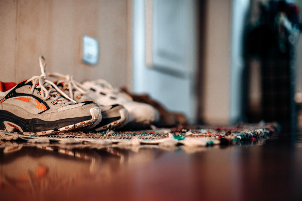 Shoes on a mat outside a home