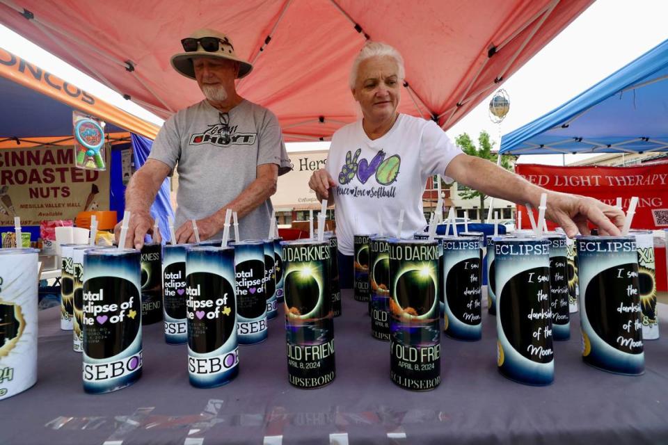 Hillsboro residents David and Robin Plumlee assemble their homemade eclipse-themed, tin cups at their stand outside the Hillsboro Courthouse on Monday, April 8, 2024. Chris Torres/ctorres@star-telegram.com