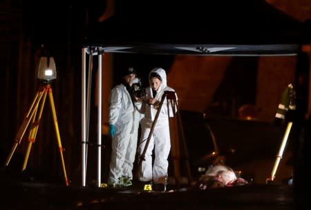 Forensic officers work at the site of a shooting in Halle