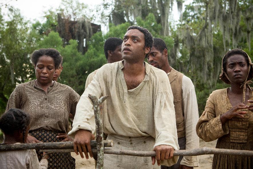 This image released by Fox Searchlight shows Chiwetel Ejiofor, center, in a scene from the film, "12 Years A Slave." Corruption tale “American Hustle,” digital love story “Her” and historic saga “12 Years a Slave” are among the motion picture nominees for the Producers Guild of America announced Thursday, Jan. 2, 2014. (AP Photo/Fox Searchlight, Jaap Buitendijk)