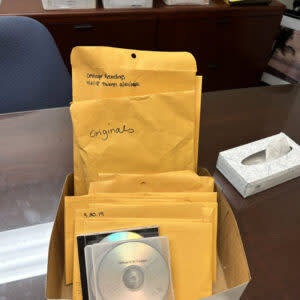 Fairfax district staff gave Callie Oettinger several boxes of documents as well as envelopes full of CDs and flash drives. (Courtesy of Callie Oettinger)