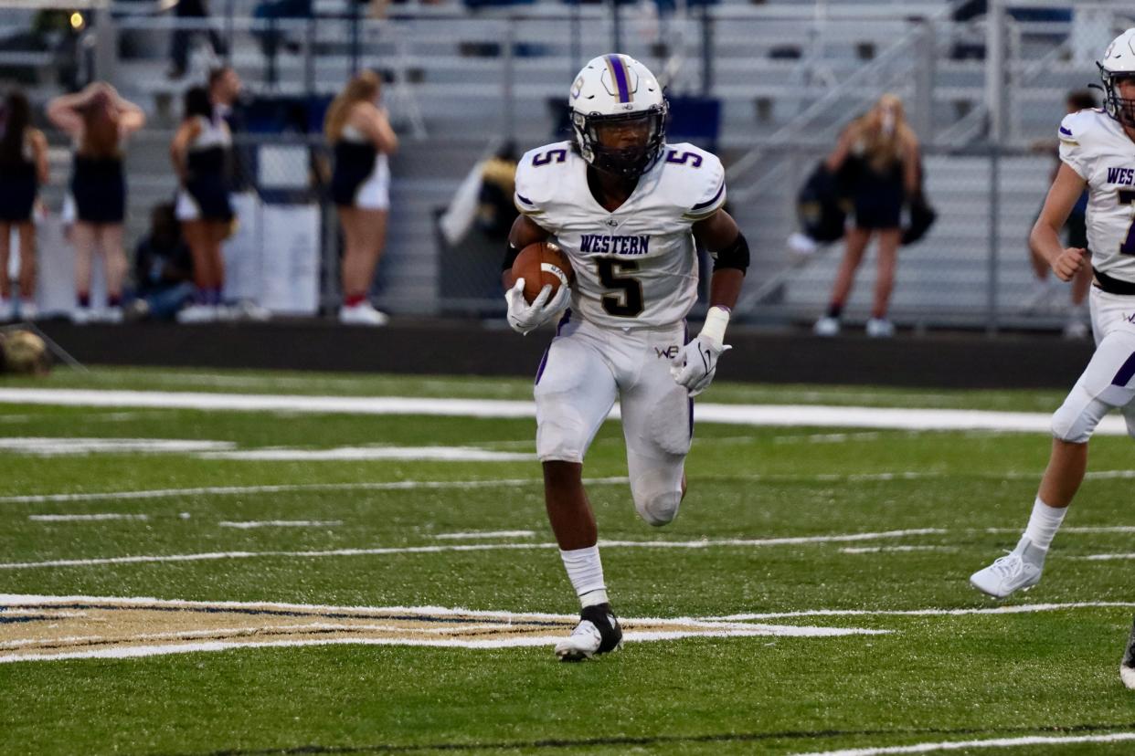 Western Beaver running back Tyson Florence breaks out a run to the outside in the Golden Beaver’s game against Hopewell Friday night.