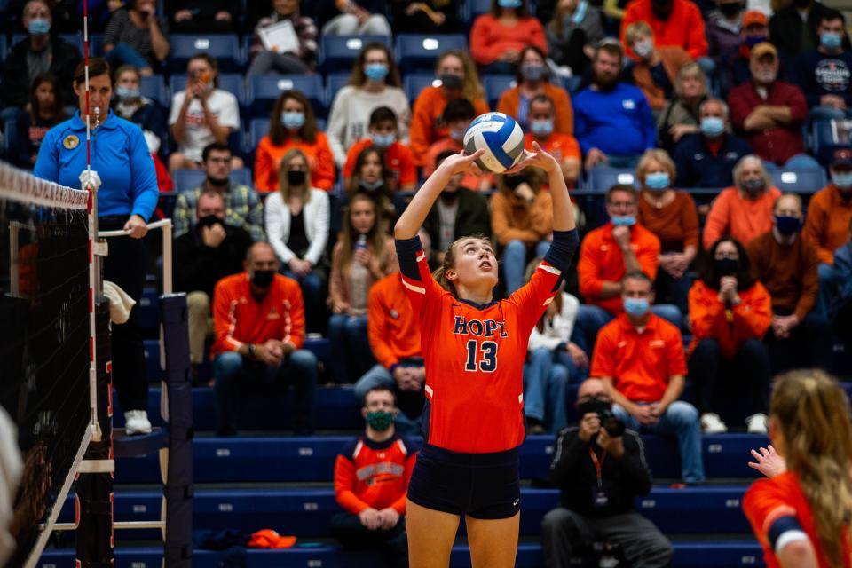 Hope's Tracy Westra sets the ball for her teammate during a game against Calvin Saturday, Oct. 30, 2021, at DeVos Fieldhouse. 