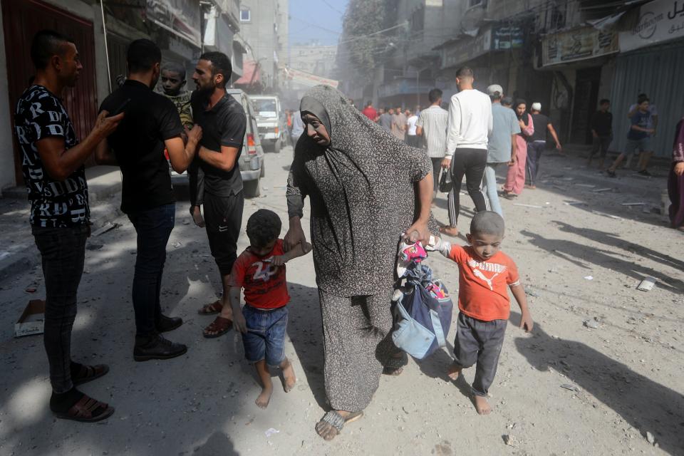 Palestinians evacuate wounded people following an Israeli airstrike in Bureij refugee camp (AP)