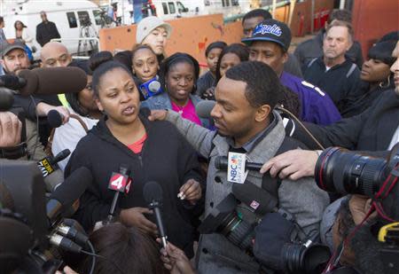 Nailah Winkfield, the mother of Jahi McMath, along with Jahi's uncle Omari Sealy (R), speak with the media outside Children's Hospital and Research Center in Oakland, California, December 30, 2013. REUTERS/Norbert von der Groeben