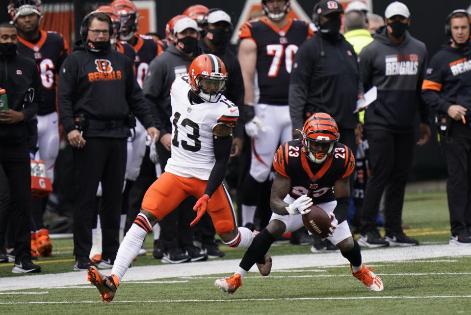 Cincinnati Bengals' Darius Phillips (23) intercepts a pass intended for Cleveland Browns' Odell Beckham Jr. (13) during the first half of an NFL football game, Sunday, Oct. 25, 2020, in Cincinnati. (AP Photo/Bryan Woolston)