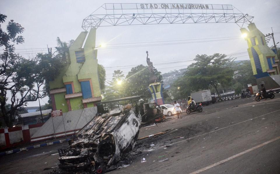 a torched car outside Kanjuruhan stadium in Malang, East Java - PUTRI/AFP