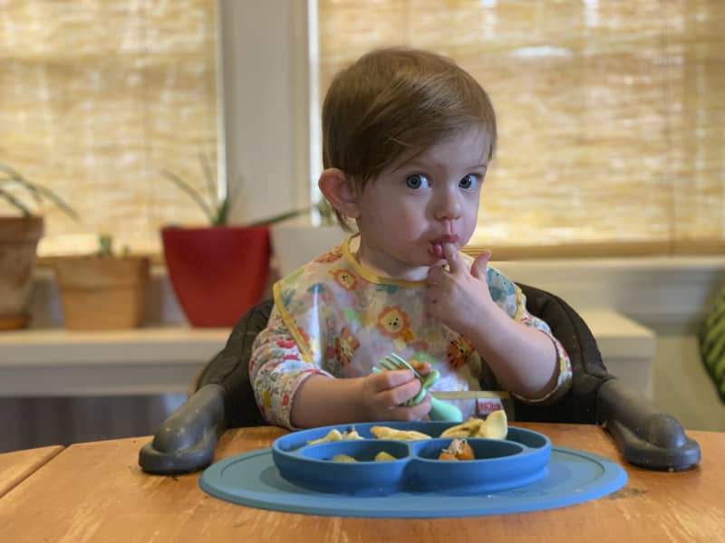 Toddler in a high seat.