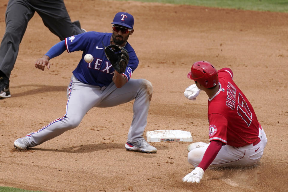 Texas Rangers second baseman Marcus Semien, left, gets ready to tag out Los Angeles Angels' Shohei Ohtani as Ohtani tries to steal second during the third inning of a baseball game Sunday, July 31, 2022, in Anaheim, Calif. (AP Photo/Mark J. Terrill)