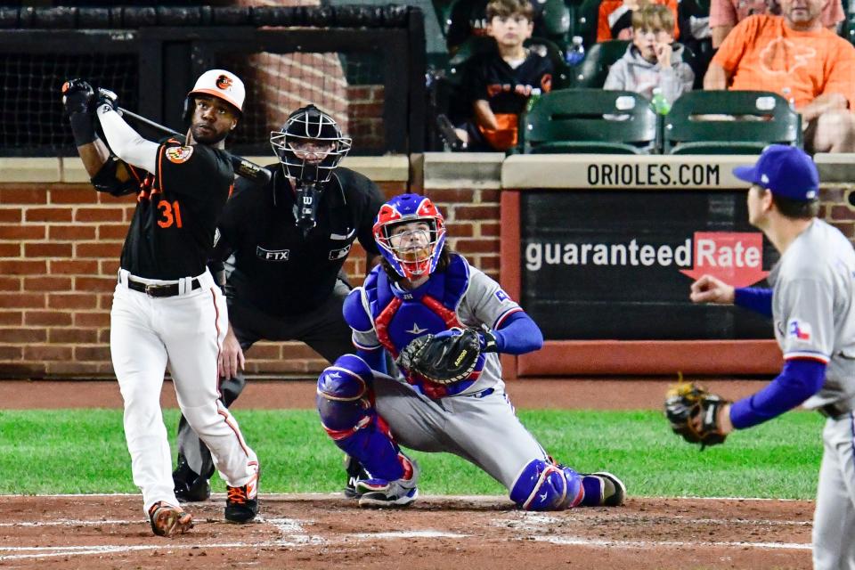 The Orioles' Cedric Mullins connects on a three-run home run against Texas. With one week left in the season, Mullins is the only MLB player to hit 30 homers and steal 30 bases.
