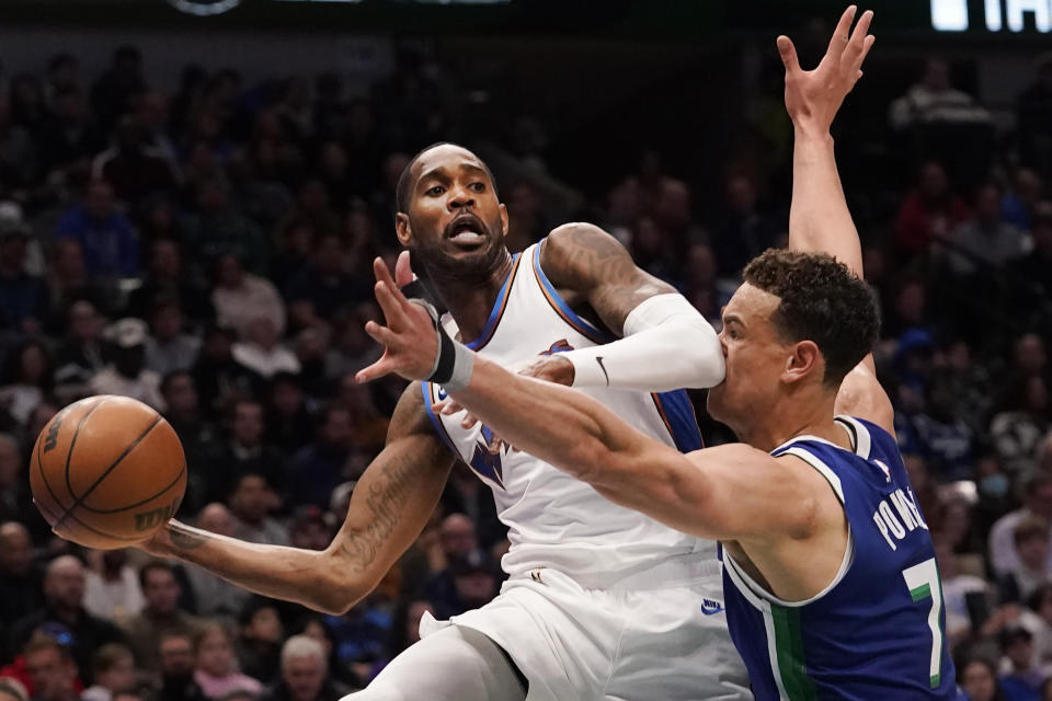 Washington Wizards forward Will Barton passes off the ball against Dallas Mavericks center Dwight Powell (7) during the first half of an NBA basketball game in Dallas, Tuesday, Jan. 24, 2023. (AP Photo/LM Otero)