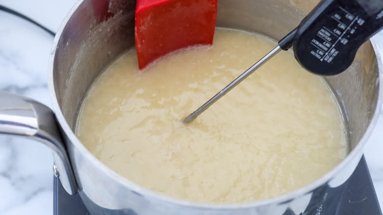 white fudge in pot with candy thermometer