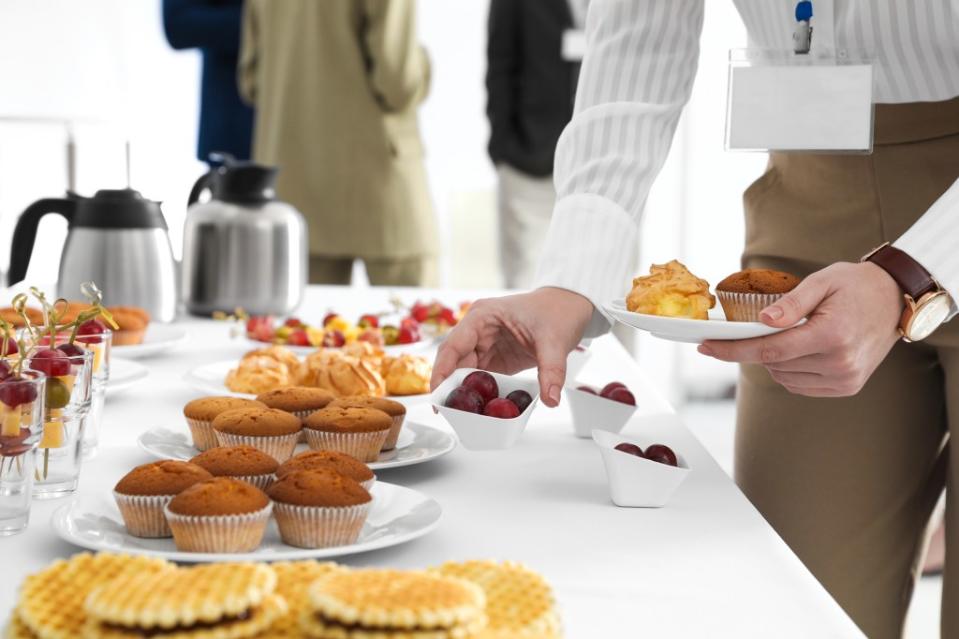 An employee is overindulging in the free snacks in the office. Getty Images/iStockphoto